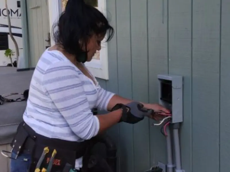 Licensed electrician wiring an exterior subpanel in Crockett